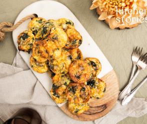 Mini Speck und Ei Frittatas auf einem Brett gestapelt.