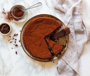 Schneller Rote-Bete-Schokoladenkuchen mit Mandeln auf einem Teller angerichtet.