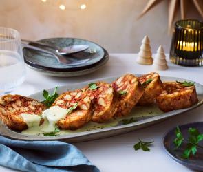 Rote Bete Knödel aufgeschnitten auf einer Servierplatte.