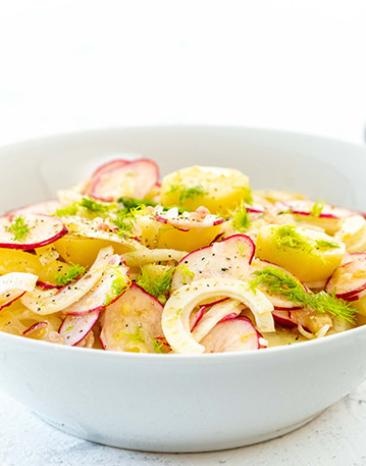 Kartoffelsalat mit Fenchel und Radieschen in einer Salatschüssel.