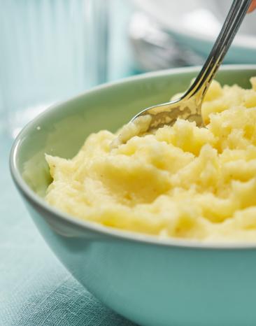 Kartoffelstampf in einer Schüssel mit Löffel.