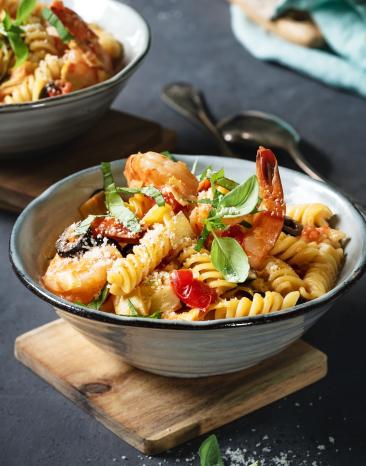 Pasta mit Artischocken und Oliven in zwei Schalen.