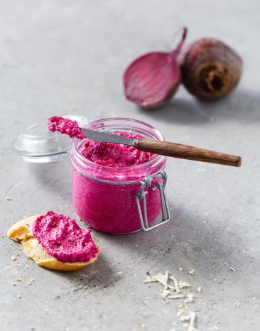 Rote-Bete-Aufstrich im Glas mit Messer und Stück Baguette Rote-Bete-Aufstrich im Glas mit Messer und Stück Baguette