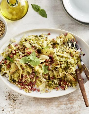 Salat mit Wirsing und Speck auf einem Teller.