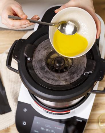 Butter wird durch die Einfüllöffnung für die Sauce Hollandaise hinzugegeben. Butter wird durch die Einfüllöffnung für die Sauce Hollandaise hinzugegeben.