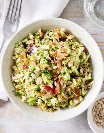 Roher Brokkoli-Salat mit Apfel in einer Schale.